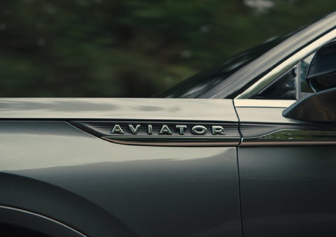 The driver’s side door and fender badging of a gray 2027 Lincoln Aviator® SUV are showcased. | South Bay Lincoln in Hawthorne CA