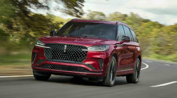A 2027 Lincoln Aviator® SUV is being driven on a country road | South Bay Lincoln in Hawthorne CA