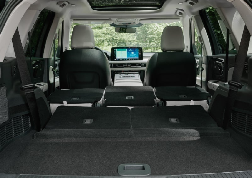 A rear to front view of the interior of a 2027 Lincoln Aviator® Black Label™ SUV shows the third and second rows folded flat | South Bay Lincoln in Hawthorne CA