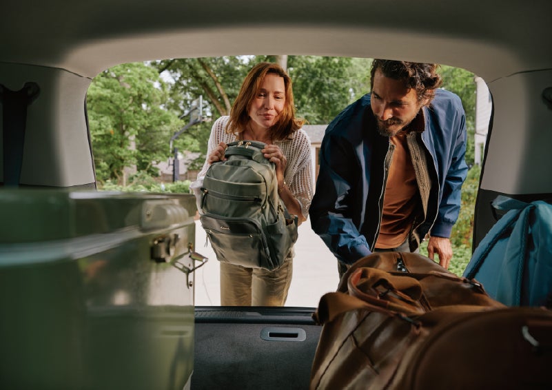 A couple loads luggage into the rear of a 2027 Lincoln Aviator® Black Label™ SUV..e 202 | South Bay Lincoln in Hawthorne CA