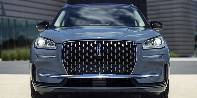 Front view of a 2024 Lincoln Aviator SUV showcasing its wide mesh grille and sleek LED headlamps.