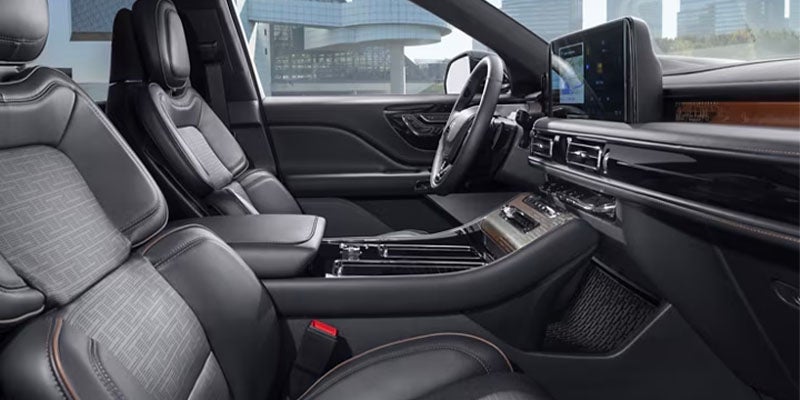 The cabin of the luxury SUV features premium seats, a multifunction steering wheel, and an advanced infotainment display.