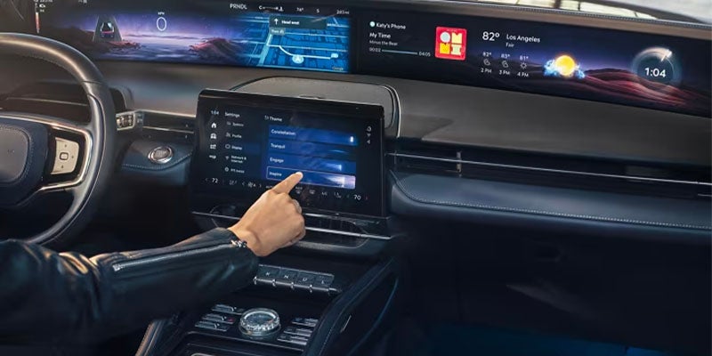 Inside the 2024 Lincoln Nautilus, a premium infotainment screen and a multifunction steering wheel displayed.
